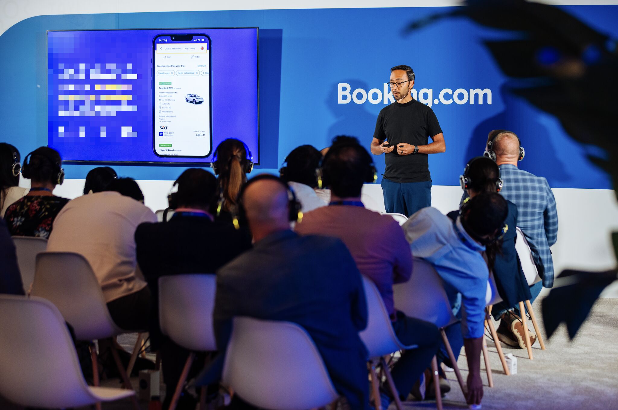 Niko Vijayaratnam presenting at a Booking.com event in Miami - 2024